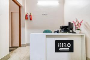 a reception desk with a hotel sign on it at Super Hotel O Jessore Road Kolkata Formerly Skyline Serenity in Kolkata