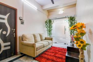 a living room with a couch and a red rug at Super Hotel O Jessore Road Kolkata Formerly Skyline Serenity in Kolkata