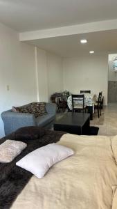 a living room with two beds and a couch at Mitre1349bis in Villa Basso
