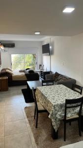 a living room with a table and a bed at Mitre1349bis in Villa Basso