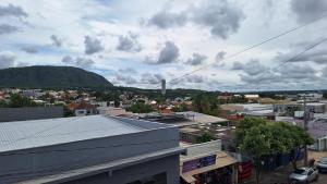 a view of a city with a mountain in the background at Apartamento no Centro Proximo a Tudo in Barra do Garças