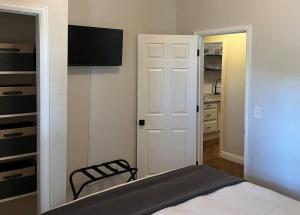 a bedroom with a bed and a tv on the wall at Downtown - Colorado Cool - Relaxing and Quiet in Colorado Springs