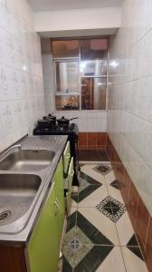 a small kitchen with a sink and a stove at Sunset - Puesta de Sol in Uyuni