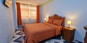 a bedroom with a large bed and a window at Sunset - Puesta de Sol in Uyuni