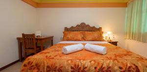 a bedroom with a bed with two pillows on it at Sunset - Puesta de Sol in Uyuni +13 photos