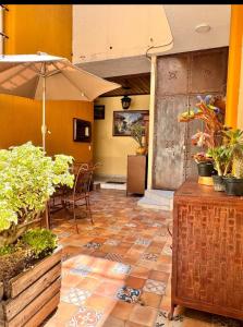 a patio with an umbrella and a table and chairs at Suites Central in Guadalajara