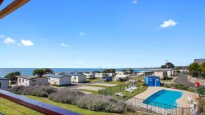 a view of a property with a swimming pool and the ocean at Iconic Luxury & Ocean Views in Apollo Bay