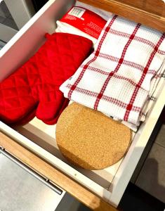 a drawer filled with red and white towels and a bread at The Extravagant Minimalist in Gatineau +40 photos
