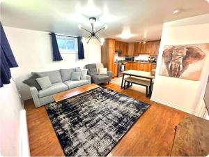 a living room with a couch and a rug at The Extravagant Minimalist in Gatineau