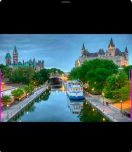 a river with boats in front of a city at The Extravagant Minimalist in Gatineau