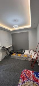 a room with two beds and a table in it at Sultana Apartments in Abha