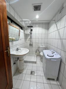 a white bathroom with a sink and a toilet at Sultana Apartments in Abha +5 photos