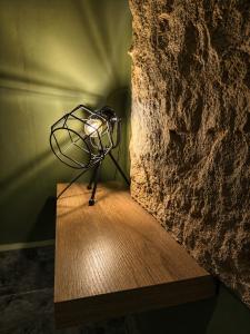 a lamp sitting on a wooden table in a room at lux bungalows in Santa Catalina