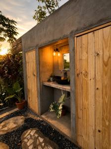 a bathroom with a sink and a wooden wall at lux bungalows in Santa Catalina
