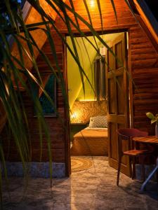 a room with a bed and a table and a plant at lux bungalows in Santa Catalina