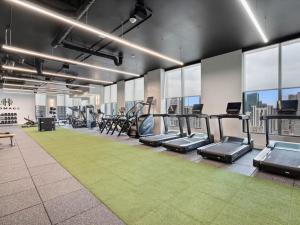 a gym with treadmills and ellipticals in a building at Miami Skyline Escape in Miami