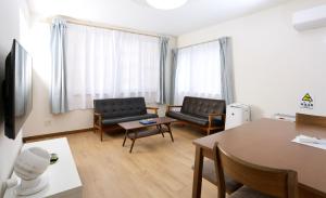 a living room with two chairs and a table at Dream Tree 札幌市电步行0分钟 超市步行1分钟 in Sapporo