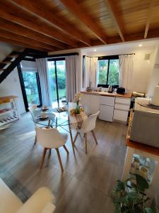 a kitchen and dining room with a table and chairs at Rincon de Luna, Cabañas in Mar del Plata