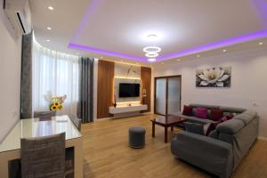a living room with a couch and a table at Garden Vila Ermali in Ksamil