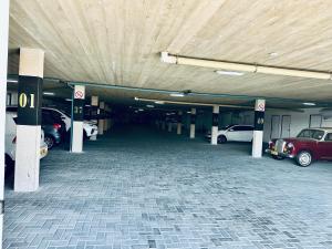 a parking garage with cars parked in it at Casa RuMat in Swakopmund +6 photos