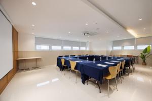 a large conference room with a long table and chairs at Kenny Stay Busan Gijang in Busan