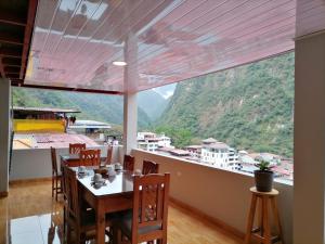 a dining room with a view of a mountain at Picos House MachuPicchu in Machu Picchu