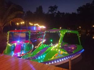 a water slide with lights on it at night at Bar Horizon Hostel in Chumphon