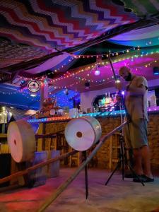 a man standing at a bar with a drum set at Bar Horizon Hostel in Chumphon +215 photos