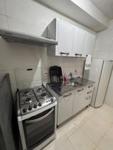 a kitchen with a stove and a sink and a refrigerator at Apartamento 2 quartos ,Mobiliado em Sumare SP in Sumaré +31 photos
