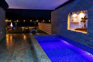 a swimming pool with purple lights next to a building at Raum Resort 1 in Suncheon +15 photos
