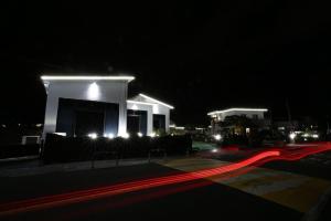 a building lit up at night with red lights at Maple Happy House Jeju in Jeju