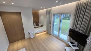 a bedroom with a bed and a sliding glass door at Maple Happy House Jeju in Jeju +22 photos