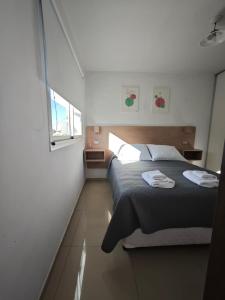 a bedroom with a bed with two towels on it at La niña in San Juan