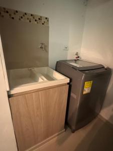 a small bathroom with a sink and a tub at Barranquilla Prime Apartment in Barranquilla +7 photos