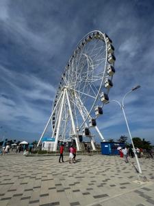a large ferris wheel with people standing around it at Barranquilla Prime Apartment in Barranquilla