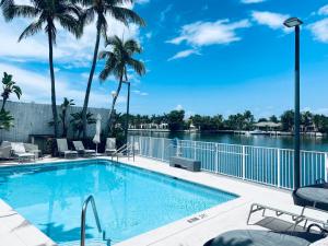 a swimming pool with a view of the water at Ocean & Bay Views 2BR 2BA Beach Condo! Parking in Miami Beach