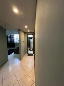 a hallway of a house with a tile floor at apartamento aconchego 01 in Divinópolis +12 photos