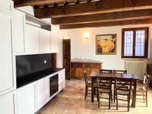 a kitchen with a table and a dining room at Apartment Stele, Pesaro in Pesaro