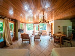 a living room with a table and chairs and a kitchen at Hotel Costa Verde in Manuel Antonio