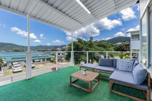 a living room with a couch and a table at Hillcrest Harmony in Airlie Beach
