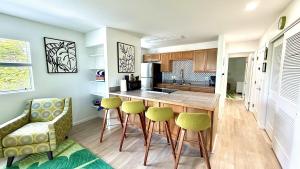 a kitchen with a counter and stools in a room at Holualoa Gardens 204 in Kailua-Kona