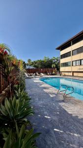 a swimming pool in front of a building at Holualoa Gardens 204 in Kailua-Kona