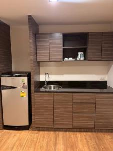 a kitchen with a refrigerator and a sink at H2 Hotel in Bangkok +33 photos