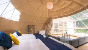 a bedroom with two beds and a large window at yamagata glam in Murayama +55 photos