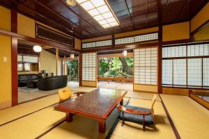 a living room with a wooden table and chairs at Hoshi in Komatsu