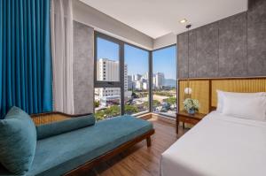a hotel room with a bed and a large window at White Sand Boutique Hotel in Danang +76 photos