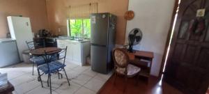a kitchen with a table and a refrigerator at Cabañas Rapanui keka in Hanga Roa
