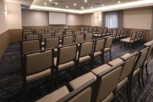 an empty lecture room with chairs and a screen at Holiday Inn Express - Monterrey - Tecnologico by IHG in Monterrey +100 photos