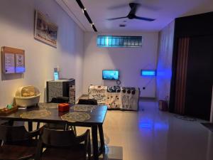 a living room with a table and a couch at HOMY guesthouse 1 - dekat pintu TOL in Ciperna