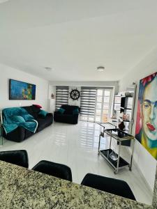 a living room with a couch and a table at Villa Corfus in Barrio El Paraíso